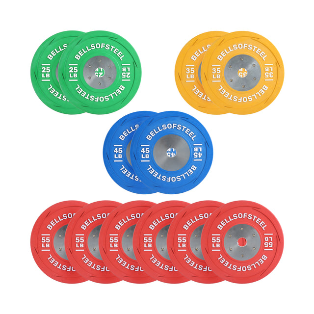 The striking arrangement consists of colorful LB Competition Bumper Plates from Bells of Steel: two 25 lb green plates, two 45 lb blue plates, one 35 lb yellow plate, and six vibrant 55 lb red plates, creating an eye-catching setup for Olympic lifting enthusiasts.