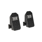 Two black, rectangular metal Footplates for Cable Tower/All In One Trainer by Bells of Steel feature angled faces, a diamond plate texture, and the white "BOS" logo—perfect accessories set against a clean white background.