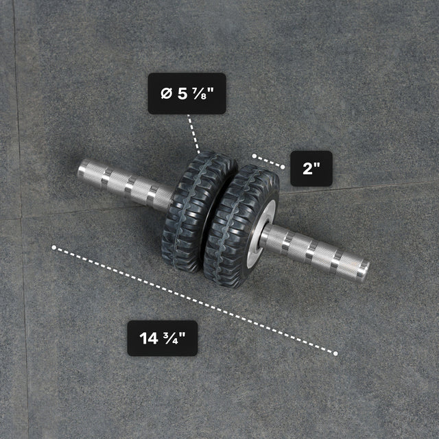 The Bells of Steel ABsyidyan Stainless Steel Ab Roller, with dual 5 5/8" x 2" wheels and a 14 3/4" handle, supports up to 500 lbs and is shown resting on a gray surface.