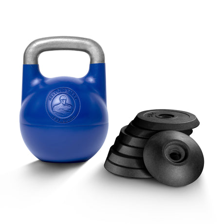 A Bells of Steel Adjustable Competition Kettlebell in blue stands beside a stack of six black weight plates, all placed on a white background.