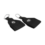 Laid out on a white background are two black nylon wrist straps from Bells of Steel, each equipped with heavy-duty carabiners. These ideal Hanging Ab Straps feature a circular patch adorned with a bird logo, perfect for use as arm hammocks.