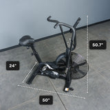 A black Bells of Steel Residential Air Bike with Wind Guard, featuring a prominent fan wheel, sits on a gray floor. Its dimensions are labeled: 50.7" tall, 24" wide, and 50" long—ideal for any home gym.