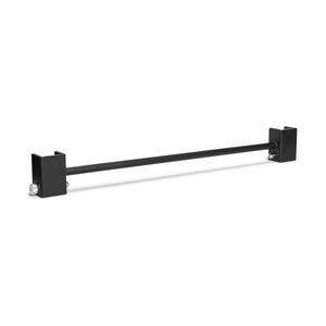 A black metal Bells of Steel Adjustable Pull-up Bar Rack Attachment features square brackets with bolt holes on each end for secure mounting. Positioned horizontally against a white background, it casts a slight shadow.