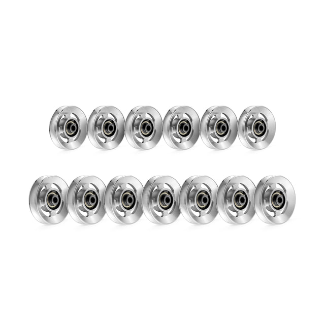 A set of 12 silver-colored pulley-like roller bearings from Bells of Steel's Aluminum Pulley Wheels & Upgrade Kits is displayed in three rows. Each has a central black ring on a plain white background.