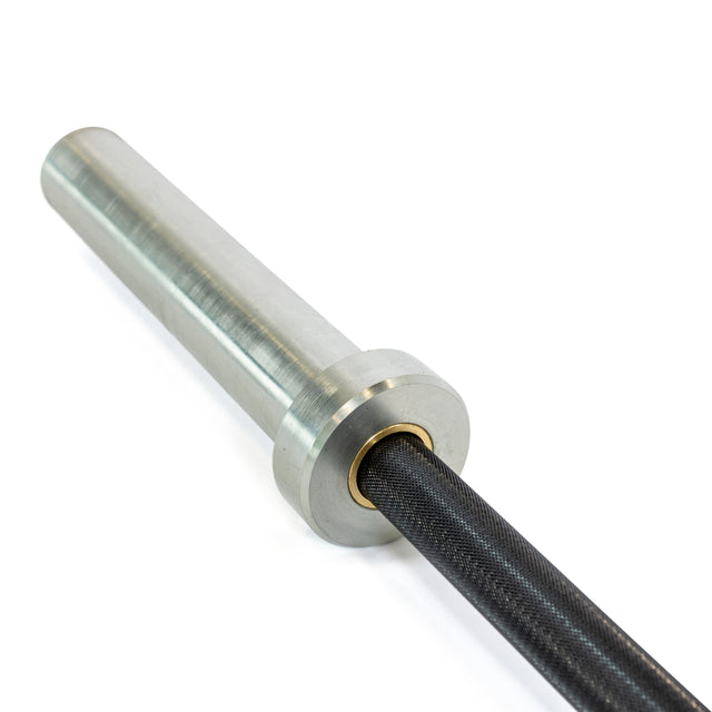 Close-up of a Rackable EZ Curl Bar by Bells of Steel, featuring the metallic cylindrical sleeve connected to a textured dark shaft. Designed for effective bicep and tricep workouts against a plain white background.