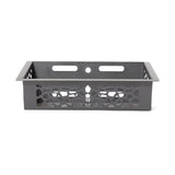 The Bells of Steel Rack Attached Storage Basket is a black rectangular metal basket with patterned cut-out sides, two horizontal slots, and a circular hole at the back—perfect for organizing gym or fitness accessories.