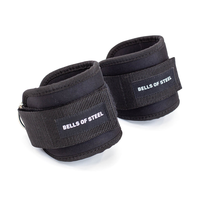 The Bells of Steel Adjustable Ankle Strap Cable Attachment - Pair comes in black with padding, adjustable velcro, and durable D-ring attachments, ideal for glute training and strength exercises.