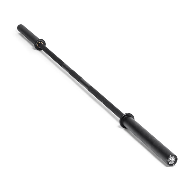 A Bells of Steel Powerlifting Bar, featuring a lengthy central shaft and robust ends for accommodating weight plates, is positioned diagonally against a plain white background, highlighting its sleek, metallic design. Ideal for those seeking the best budget power bar for their lifting needs.