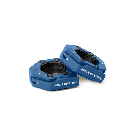 Two blue Magnetic Clamp Collars by Bells of Steel are shown on a white background. One collar rests on its side, leaning against the other, both designed to securely fasten weights to a barbell.