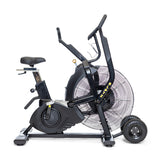 The Bells of Steel Blitz Max Air Bike, featuring a large front fan, adjustable seat, pedals, and handlebars, is shown in profile on a white background.