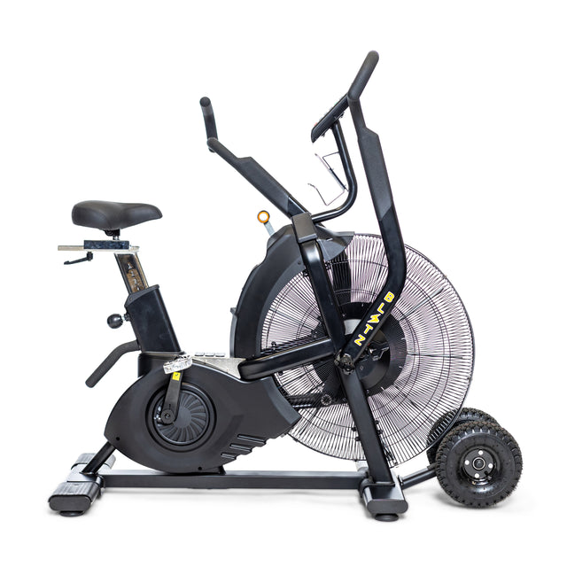The Bells of Steel Blitz Max Air Bike, featuring a large front fan, adjustable seat, pedals, and handlebars, is shown in profile on a white background.
