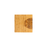 A rectangular bamboo insert, branded as the Deadlift Platform Bamboo Insert (Left) by Bells of Steel Canada, has a smooth surface and displays a dark brown emblem on the right side. This emblem features an oval football shape with the letters "BELL," while "STEEL" is partially visible. The wood boasts a natural, light finish with visible grain patterns, providing an elegant touch.