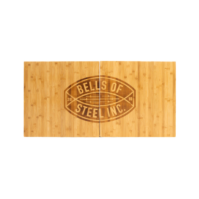 The Bells of Steel Deadlift Platform Bamboo Insert features two rectangular bamboo boards side by side, a large engraved logo in the center, and the years "20" and "10," making it a durable choice for any lifting platform.