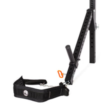 The Belt Squat/Lever Arms Rack Attachment by Bells of Steel includes adjustable levels, an angled support arm, and a safety strap with carabiner. Designed with multiple holes for customization, its sleek look is shown against a white background.