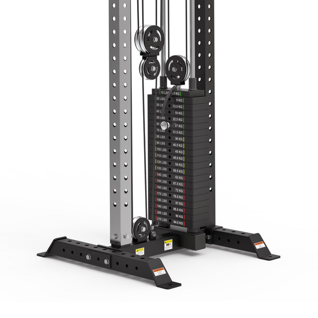 The Bells of Steel Cable Tower features labeled weight plates on a pulleys system, securely bolted onto a robust black base. Weights are marked in pounds and kilograms, ideal for versatile exercises.