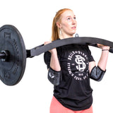 Female athlete lifting Swiss bar with Classic Elbow Sleeves