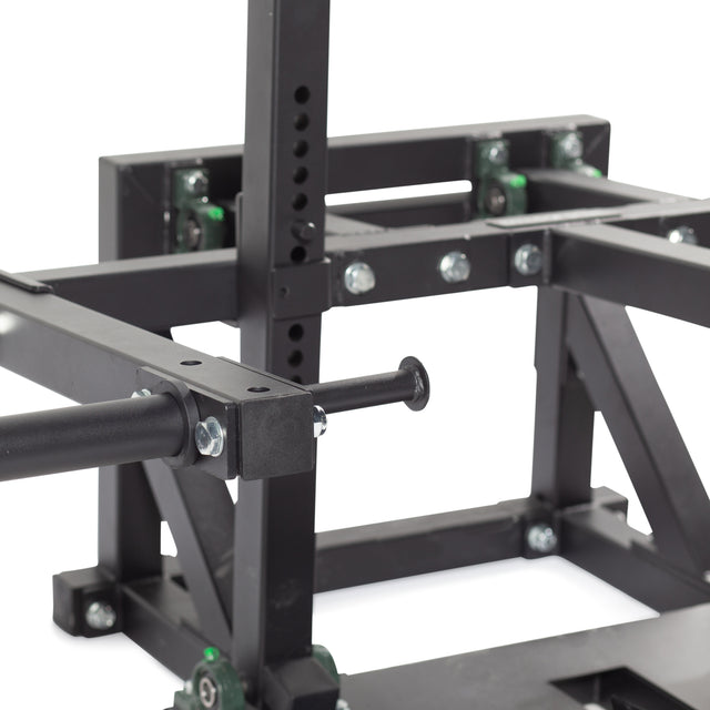 Close-up of a black metal frame with bolts and green casters, resembling gym equipment from Bells of Steel's Belt Squat Machine. Ideal for home gyms, the image showcases connection points and mechanical details to boost lower body strength.