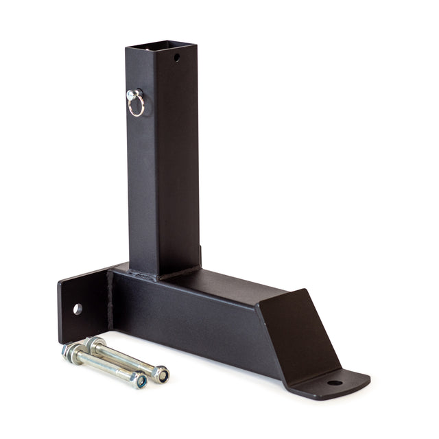 A black metal Bench Attachments piece by Bells of Steel, featuring a rectangular base and vertical post, functions as a Model-Matching Adapter with a securing pin. Two bolts are positioned beside it on the white background, prepared for precise assembly.