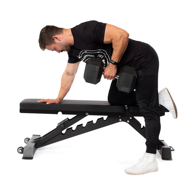 A man in athletic attire uses the Buzz-Saw Heavy-Duty Adjustable Bench by Bells of Steel, which offers 8 back pad angles, to perform a one-arm dumbbell row. Supporting himself with his left arm, he lifts a large dumbbell with his right against a plain white background.