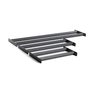 The Bumper Plate Pins Shelf by Bells of Steel features four black metal wall brackets, each with a simple rectangular shape and end holes for easy mounting, perfect for supporting shelves or similar fixtures to efficiently and stylishly organize your space.