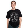 A woman smiles in a Bells of Steel Bamboo T-Shirt, which features a white "BELLS OF STEEL 25 KG" weight plate graphic on the front. She stands against a plain white background.