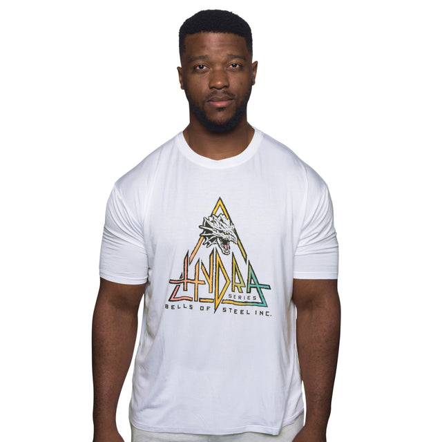 A man faces forward wearing a white Bamboo T-Shirt by Bells of Steel, featuring a colorful Hydra Series dragon logo. The background is plain white.