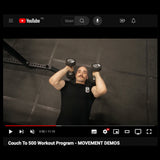 A person in a black shirt demonstrates a chest press on the gym floor using dumbbells in the "Couch to 500kg - Workout Program (Digital Product)" by Bells of Steel.
