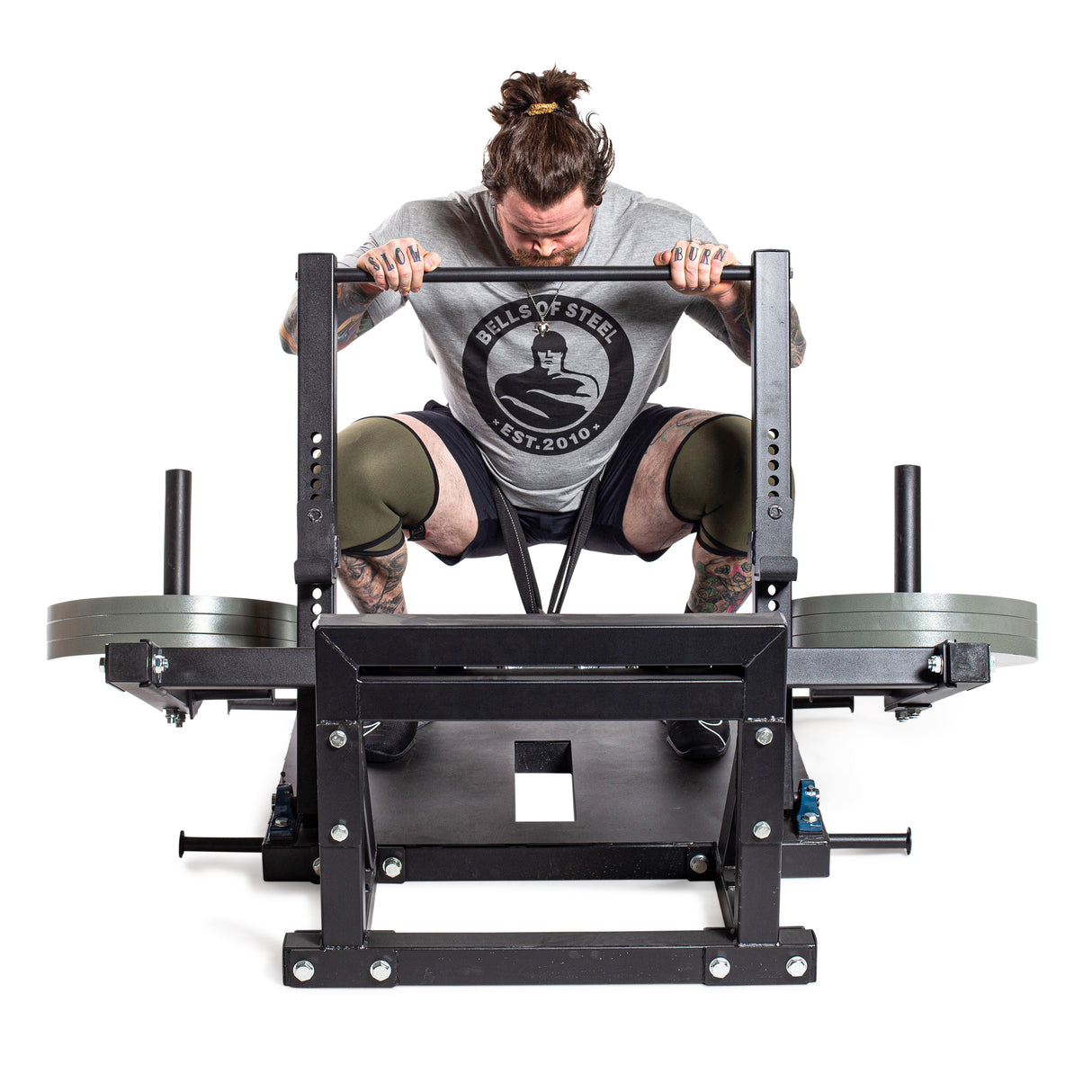 Male athlete using squat machine using Machined iron Olympic weight plates