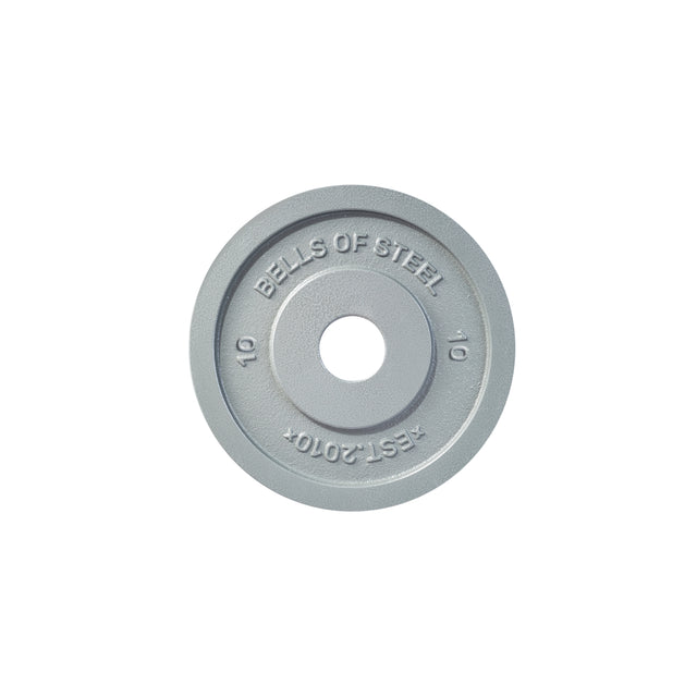 A machined iron Olympic weight plate in gray, engraved with "BELLS OF STEEL" and "EST. 2010," features a precision hole fit and displays the numerical marking "10" to indicate its weight. This slimmer plate stands out against the clean white background.