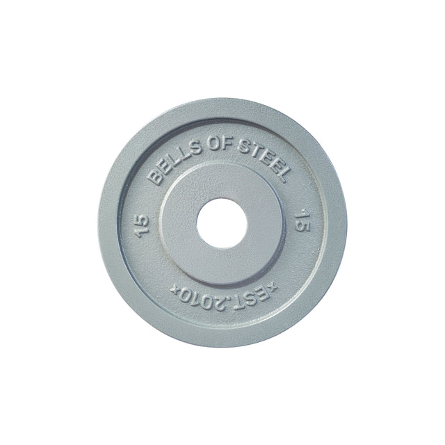 This Machined Iron Olympic Weight Plate from Bells of Steel is a gray plate weighing 15 kilograms, featuring engravings of "BELLS OF STEEL," "EST. 2010," and "15." It is crafted with a precision hole for seamless mounting on a barbell.