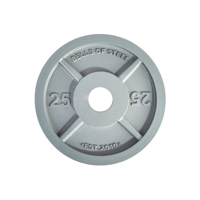 A Machined Iron Olympic Weight Plate from Bells of Steel, featuring a circular design with "25" engraved on opposite sides. Engraved with "BELLS OF STEEL" and "EST. 2010," this gray iron plate includes a precision hole in the center for perfect compatibility with slimmer weight plates.