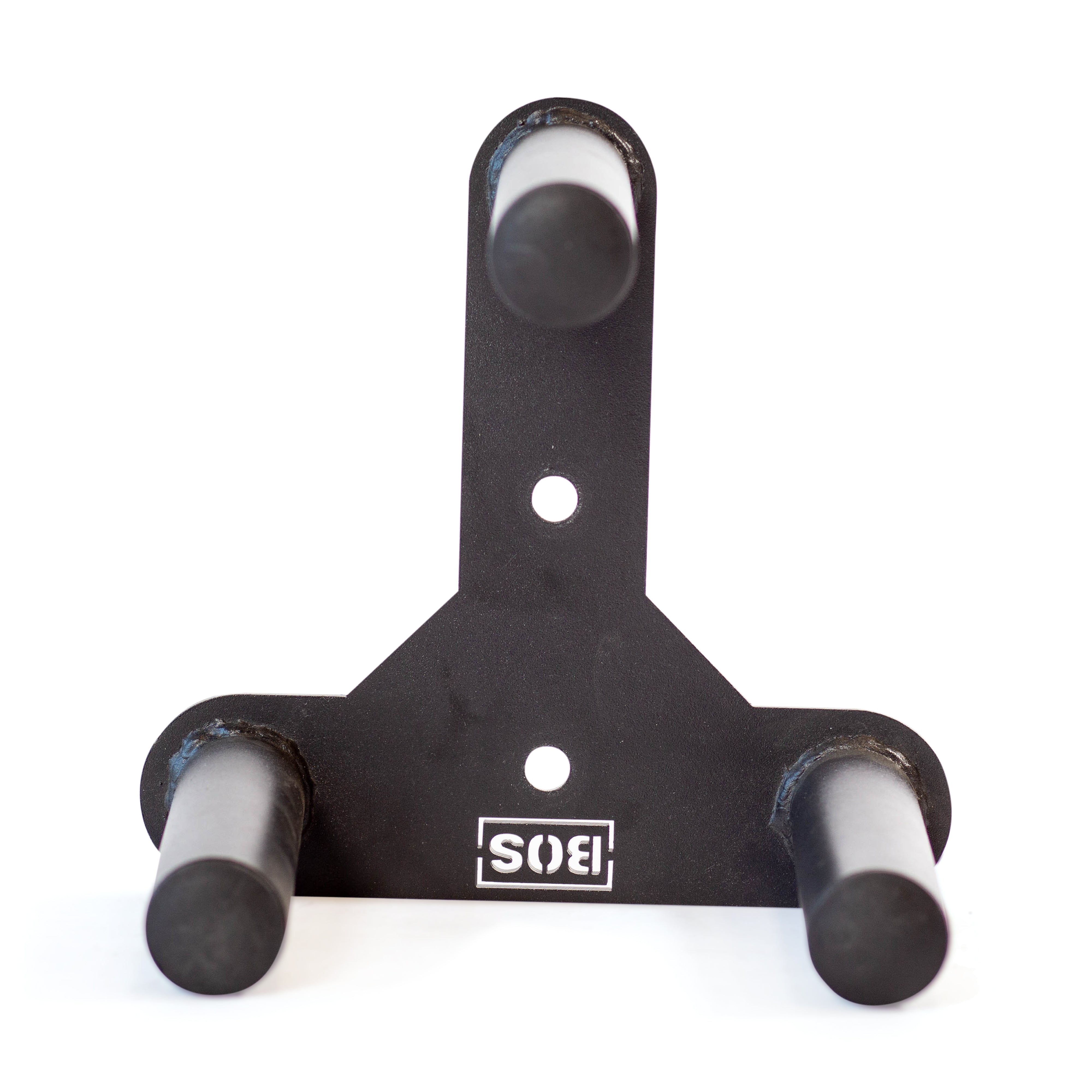 The Change Plate Storage Pegs by Bells of Steel is a wall-mounted black metal bracket featuring three cylindrical pegs designed for holding items. The pegs extend outward and include UHMW protection, with a small logo at the bottom for added detail.