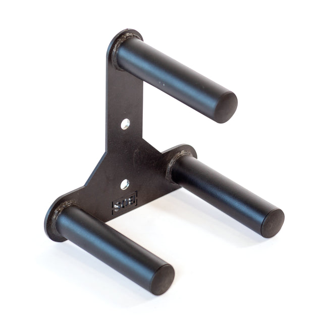 The Bells of Steel Change Plate Storage Pegs, a black metal wall-mounted holder, features three sturdy pegs for organizing plates against a plain white background.