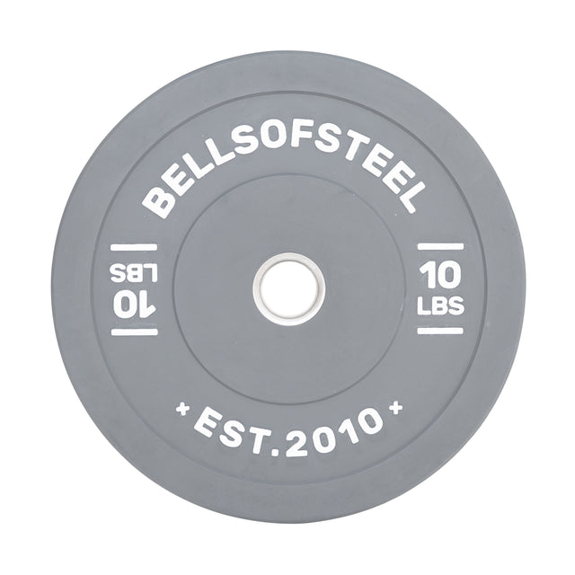 The gray Coloured Bumper Plate by Bells of Steel features "BELLSOFSTEEL" and "EST. 2010" in bold white text, an accurate weight, a durable stainless steel insert, and "10 LBS" marked on both sides around the center hole.