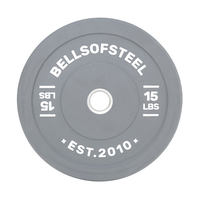 The Bells of Steel Coloured Bumper Plates feature gray plates with white "Bells of Steel" on top and "15 LBS" on the sides. Made for durability, they include a stainless steel insert ring, display "Est. 2010," promise accuracy, and have a central hole for easy mounting.