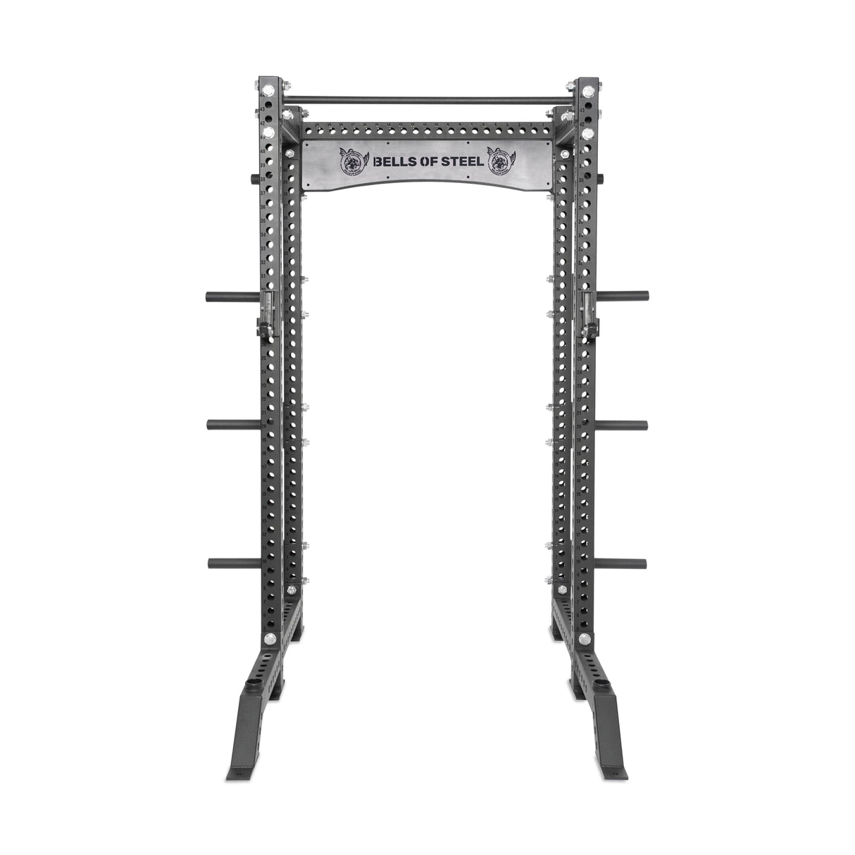 Against a white backdrop, the Manticore Collegiate Power Rack Builder by Bells of Steel features 3" x 3" uprights with 1" holes, modular components like weight pegs and a pull-up bar. The brand logo is on the crossbar, emphasizing its open ecosystem design.