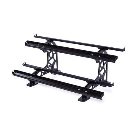 The Bells of Steel Commercial Interchangeable Weight Rack is a black metal roof rack with three horizontal bars, supporting brackets, and a swappable storage shelf for gear organization. Pictured on a white background.
