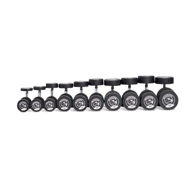 A set of ten Bells of Steel Urethane Dumbbells, commercial-grade quality with black cylindrical urethane heads, stainless steel handles, and silver weight markings. Arranged from smallest to largest in a single row on a plain white background.