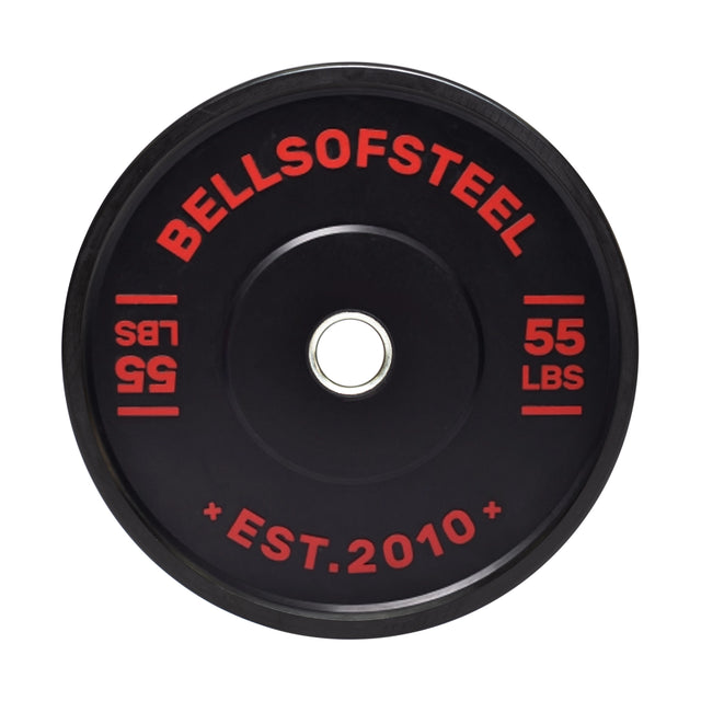 A 55-lb Dead Bounce Conflict Bumper Plate features red lettering with "BELLSOFSTEEL" and "EST. 2010" around the center hole, and has a durable stainless steel insert for lasting performance.