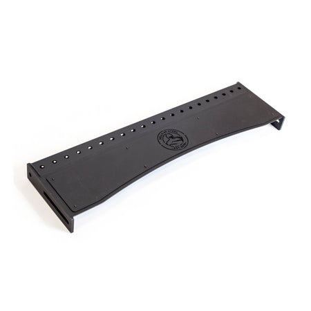 A black metal bracket with numerous holes along the edges and a circular logo in the center, closely resembling a product from Bells of Steel's Logo Plate Crossmembers. Its industrial design suggests functionality, potentially for mounting or support purposes.