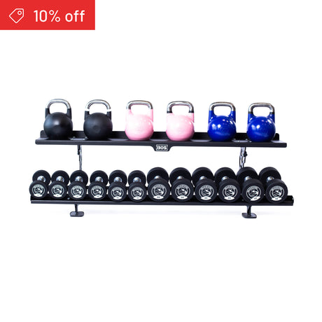 A red “10% off” label appears on the top left of the Bells of Steel Commercial Interchangeable Weight Rack, which holds three black, two pink, and two blue competition kettlebells above black urethane dumbbells on its swappable bottom shelf.