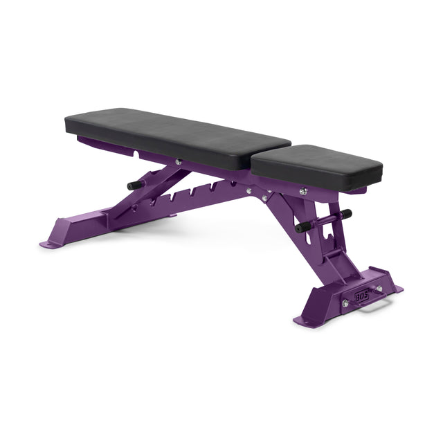 The Buzz-Saw Heavy-Duty Adjustable Bench by Bells of Steel is a purple bench with black padding and a strong metal frame. It's perfect for any exercise routine and features a flat surface, an inclined backrest, and footrests for stability, making it versatile and robust.