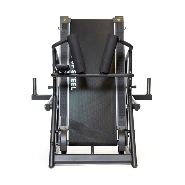 Bells of Steel's The Dreadmill is a black leg press machine with padded supports and a sturdy metal frame for lower body strength training. It includes side handles for stability and a magnetic resistance lever, displayed against a plain white background.