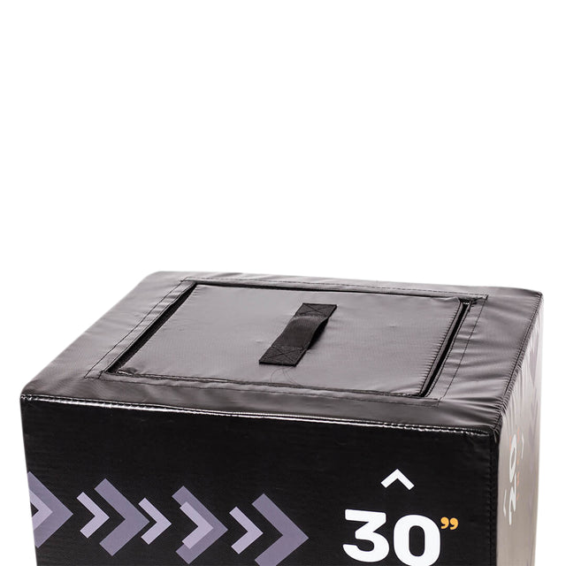 A close-up of the top corner of a black Bells of Steel 6-In-1 Soft Foam Plyo Box / Squat Box shows a handle on top and “30”” in white on the side, with arrows highlighting this space-saving exercise equipment.