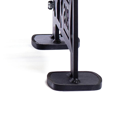 Close-up of a black, wrought-iron stand with a decorative design. The focus is on the two rectangular bases supporting the vertical structure against a white background, ideal for organizing swappable storage shelves or displaying competition kettlebells. This product is the Commercial Interchangeable Weight Rack - Components Only by Bells of Steel.