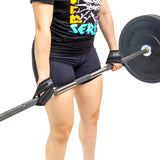 Wearing black workout shorts, a graphic T-shirt, and Bells of Steel Classic Figure 8 Lifting Straps, a person lifts a barbell near their thighs against a plain white background.