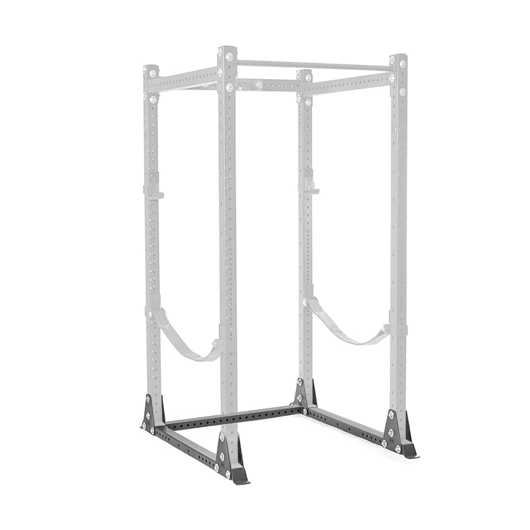 The Hydra Flat Foot Support System by Bells of Steel is a gray power rack equipped with adjustable safety straps and multiple holes to accommodate varied barbell heights. It features a sturdy base with flat foot support and black corner supports. Ideal for weightlifting, it includes reinforcement plates perfect for strength training exercises.