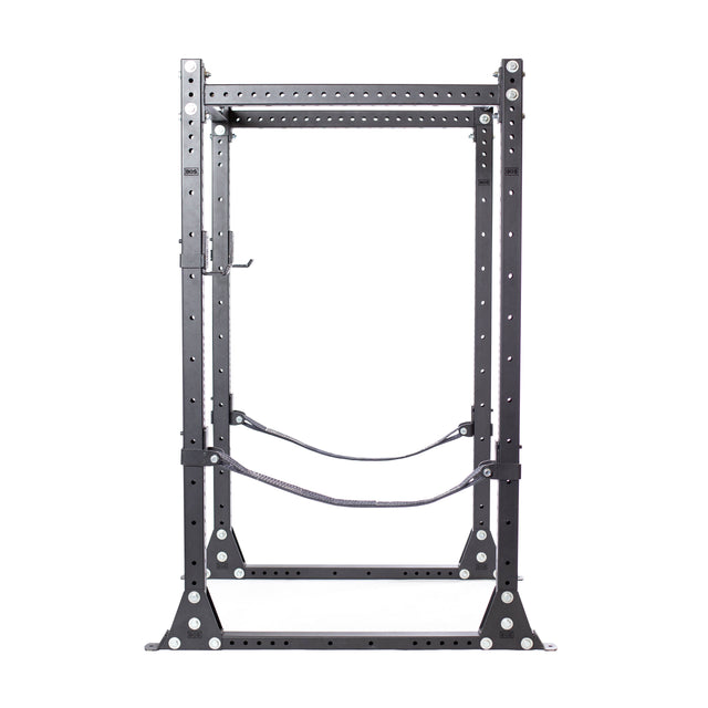 The Bells of Steel Hydra Flat Foot Components, a black metal power rack, features adjustable safety bars and multiple holes for customization. Ideal for weightlifting exercises, its sturdy structure ensures stability and is set against a plain white background.