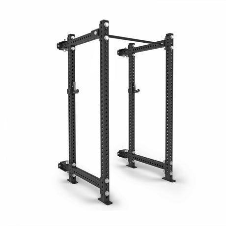 The Bells of Steel Manticore Folding Power Rack - Prebuilt (3" x 3", 1" Holes) is a black metal rack with four uprights, two horizontal bars, and barbell attachments—perfect for any home gym.