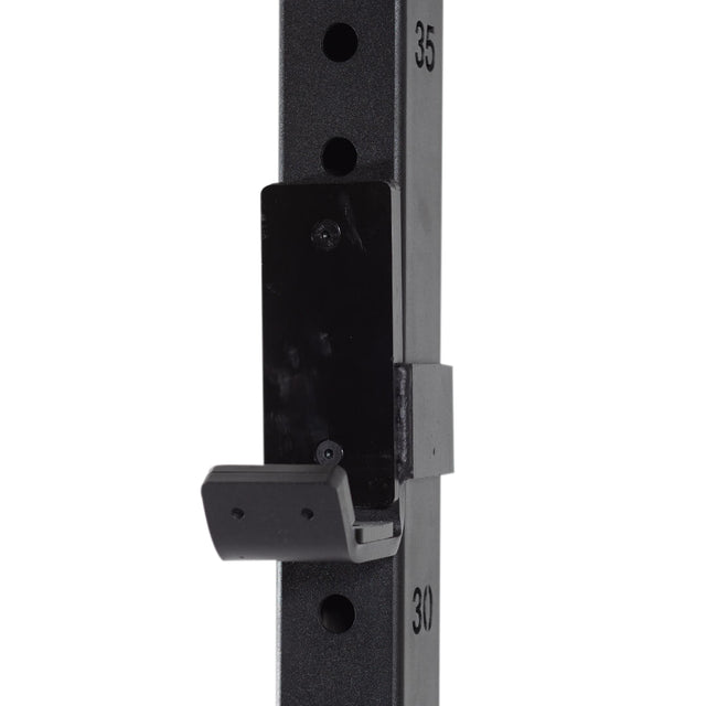 Close-up of the Bells of Steel Folding Rack 2.3" x 2.3" with 5/8" holes, a black metal wall-mounted squat rack upright featuring numbered holes and a J-cup at the 30 mark, supporting up to 600 lbs—ideal for garage gyms.